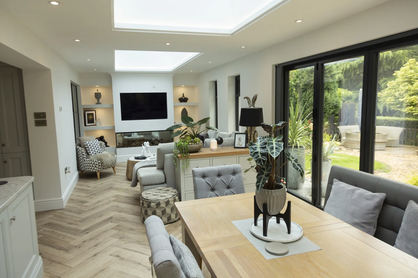 Lovely long open plan living room extension with herringbone flooring