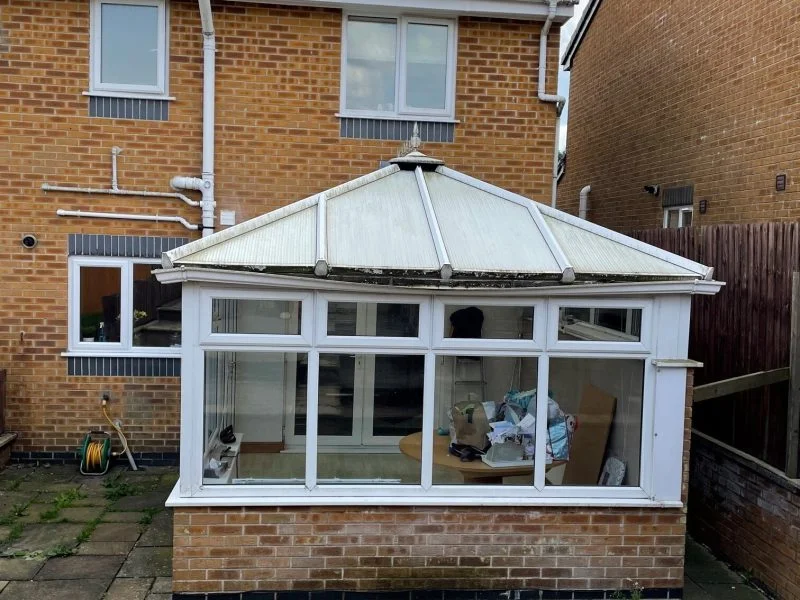 Old and dated UK conservatory in white