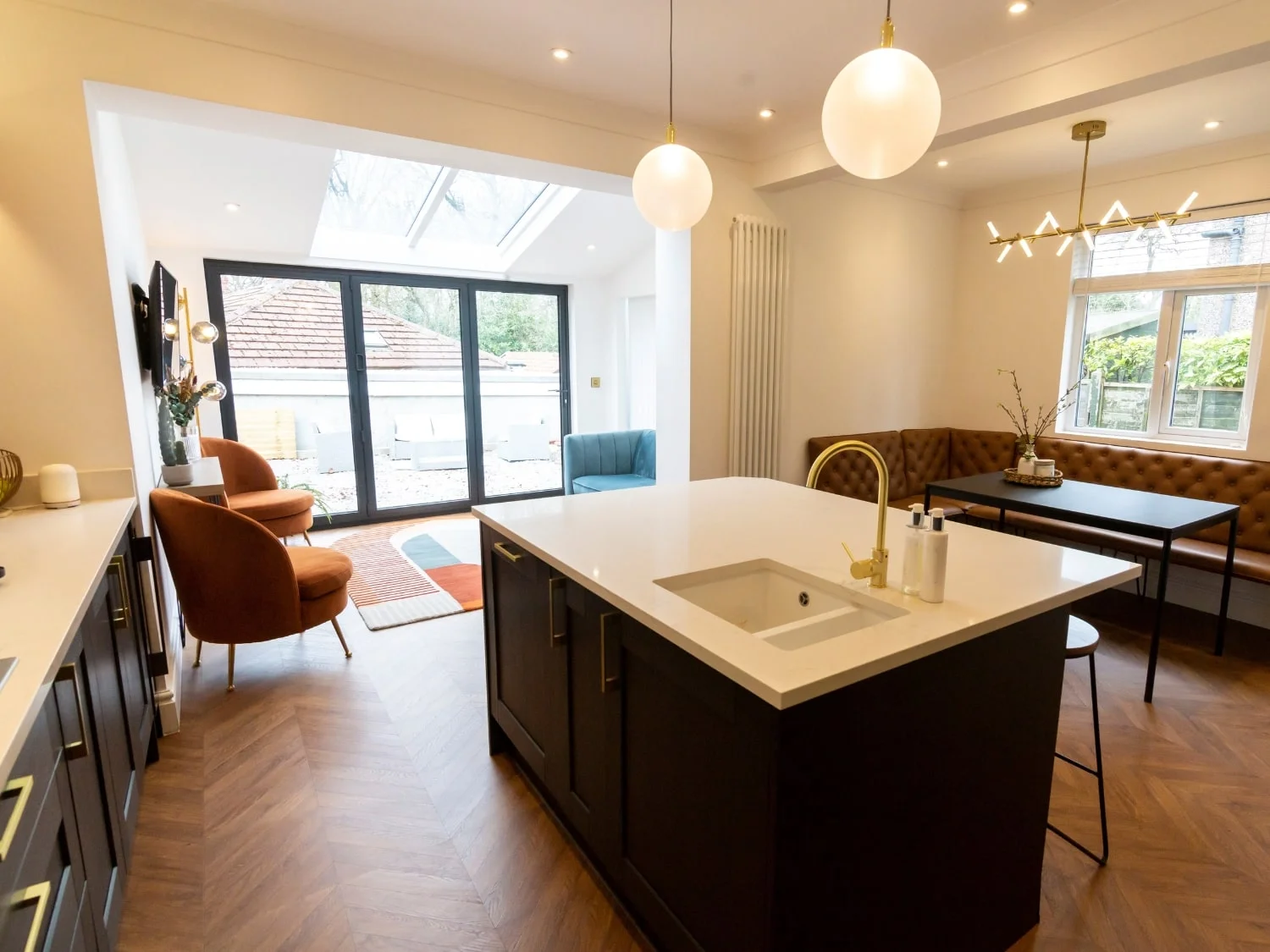 Open plan space with modern kitchen and colourful seating area