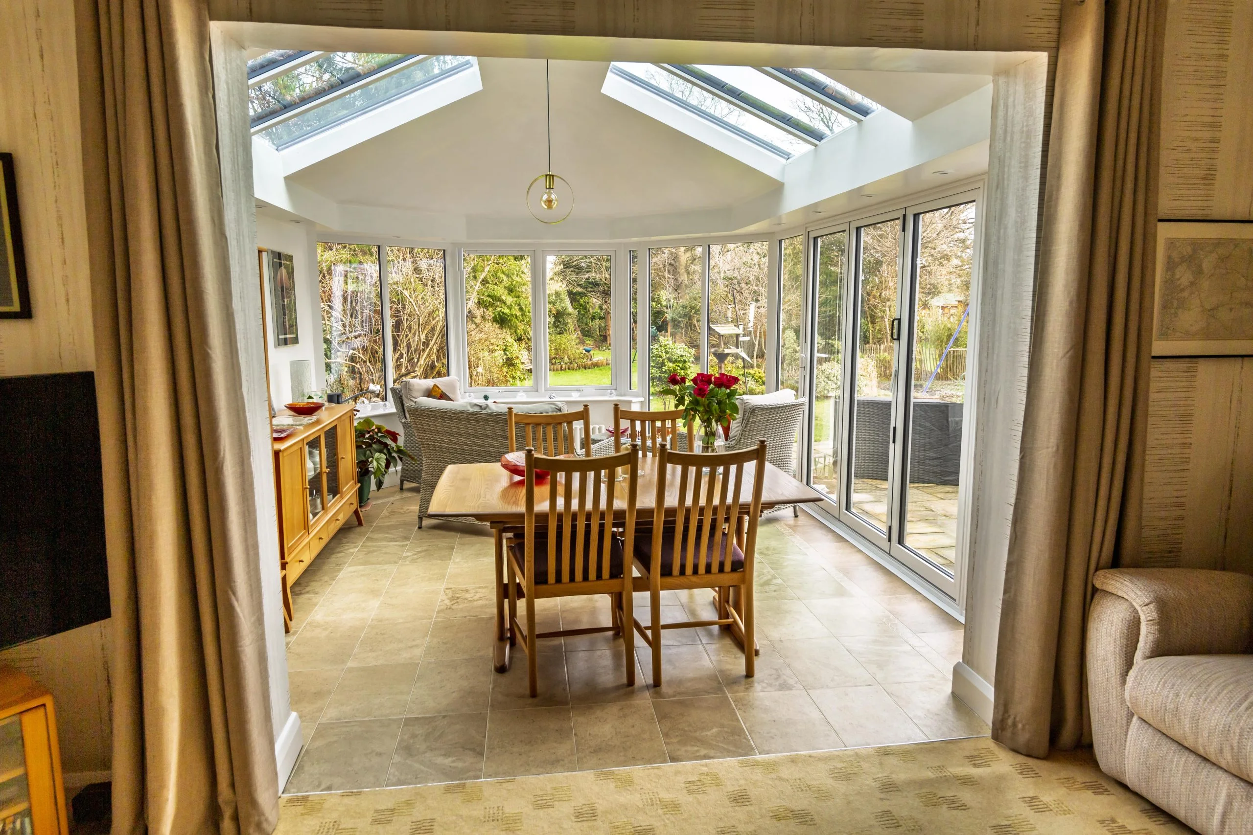 Victorian conservatory conversion with oak furniture and dining table