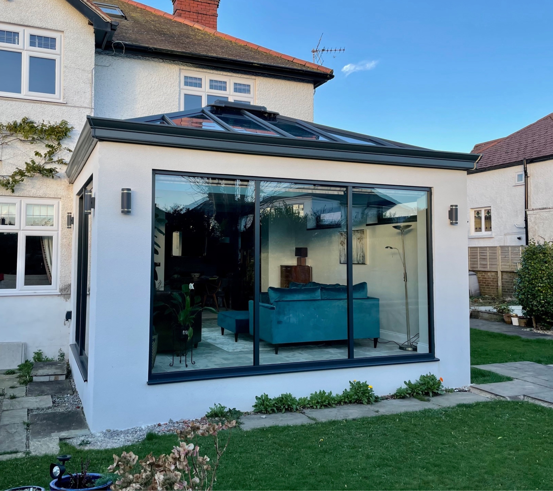 UK semi-detached house with rear extension with white render finish