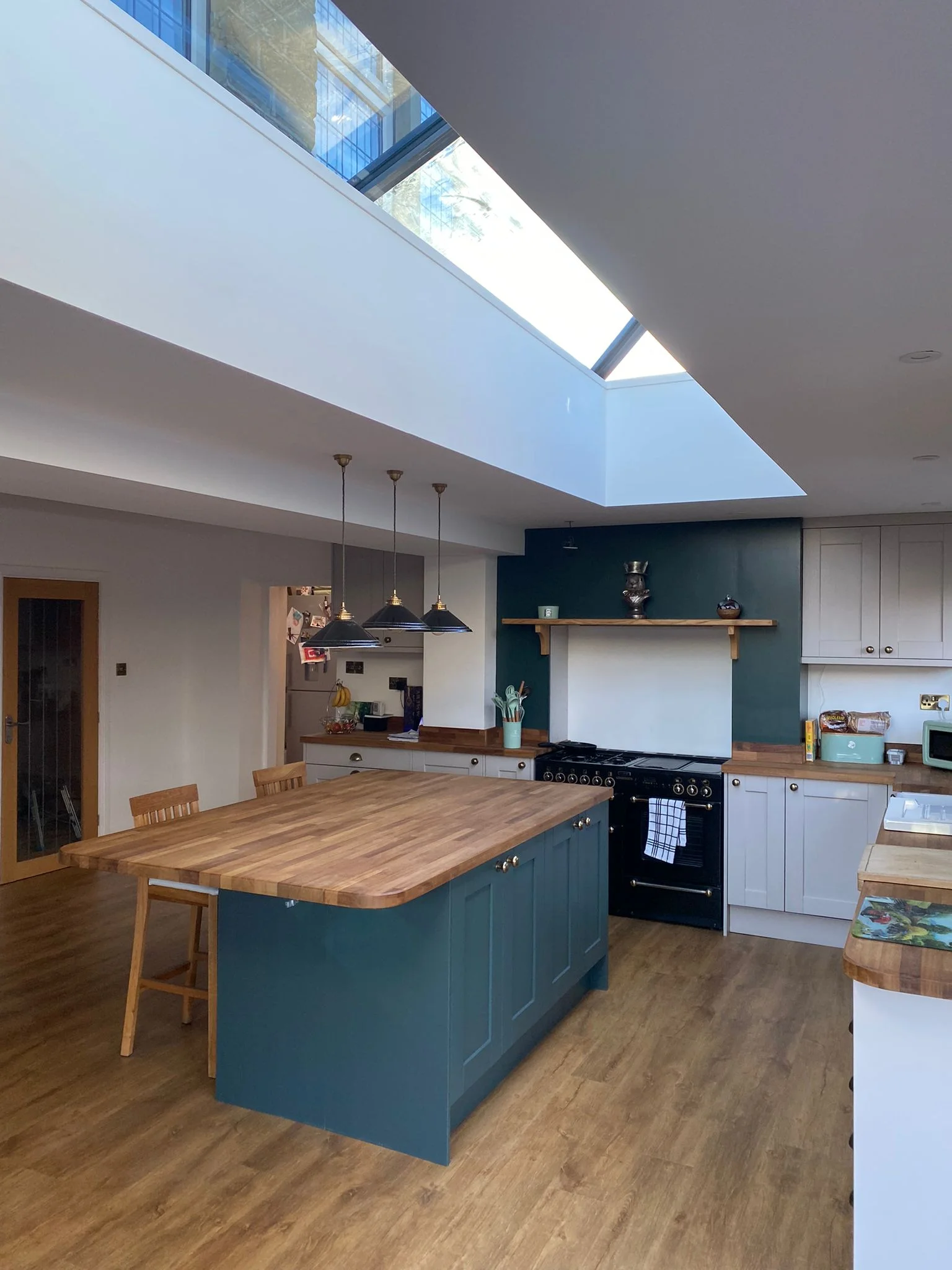 Spacious kitchen extension with oak countertops and lantern style roof