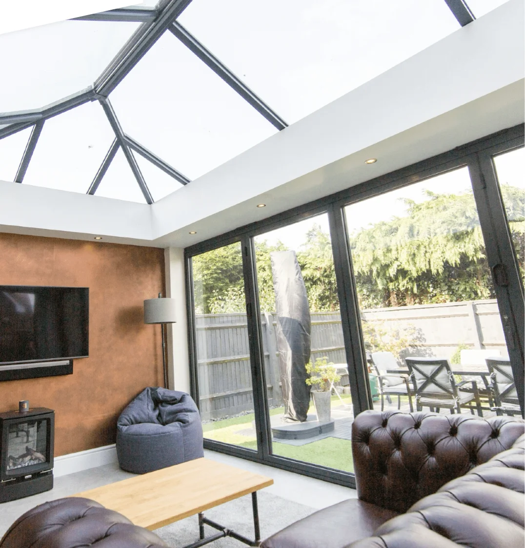 hup! orangery extension with wall-mounted TV and traditional sofa