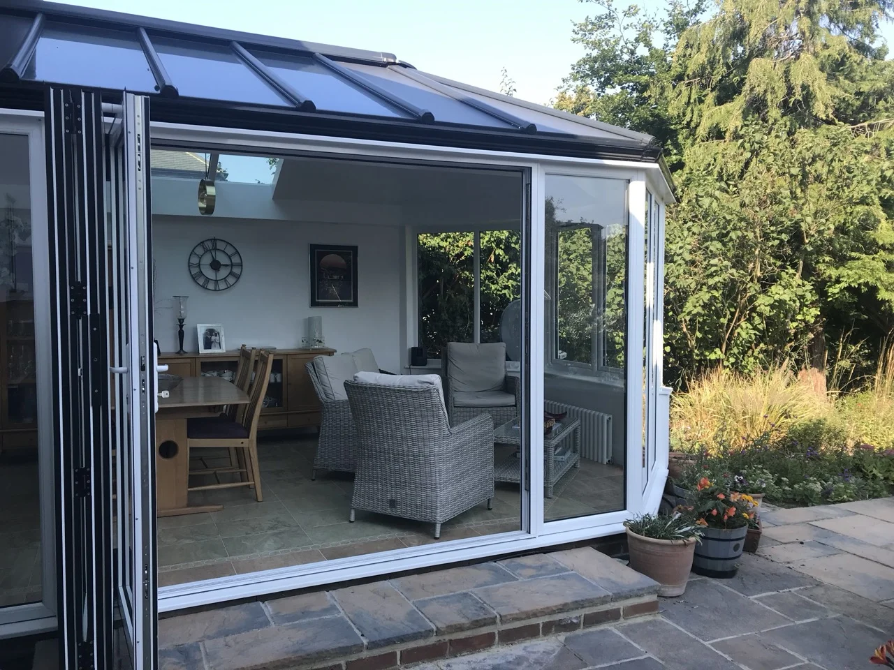 Outdoor view of garden patio and modern Victorian conservatory