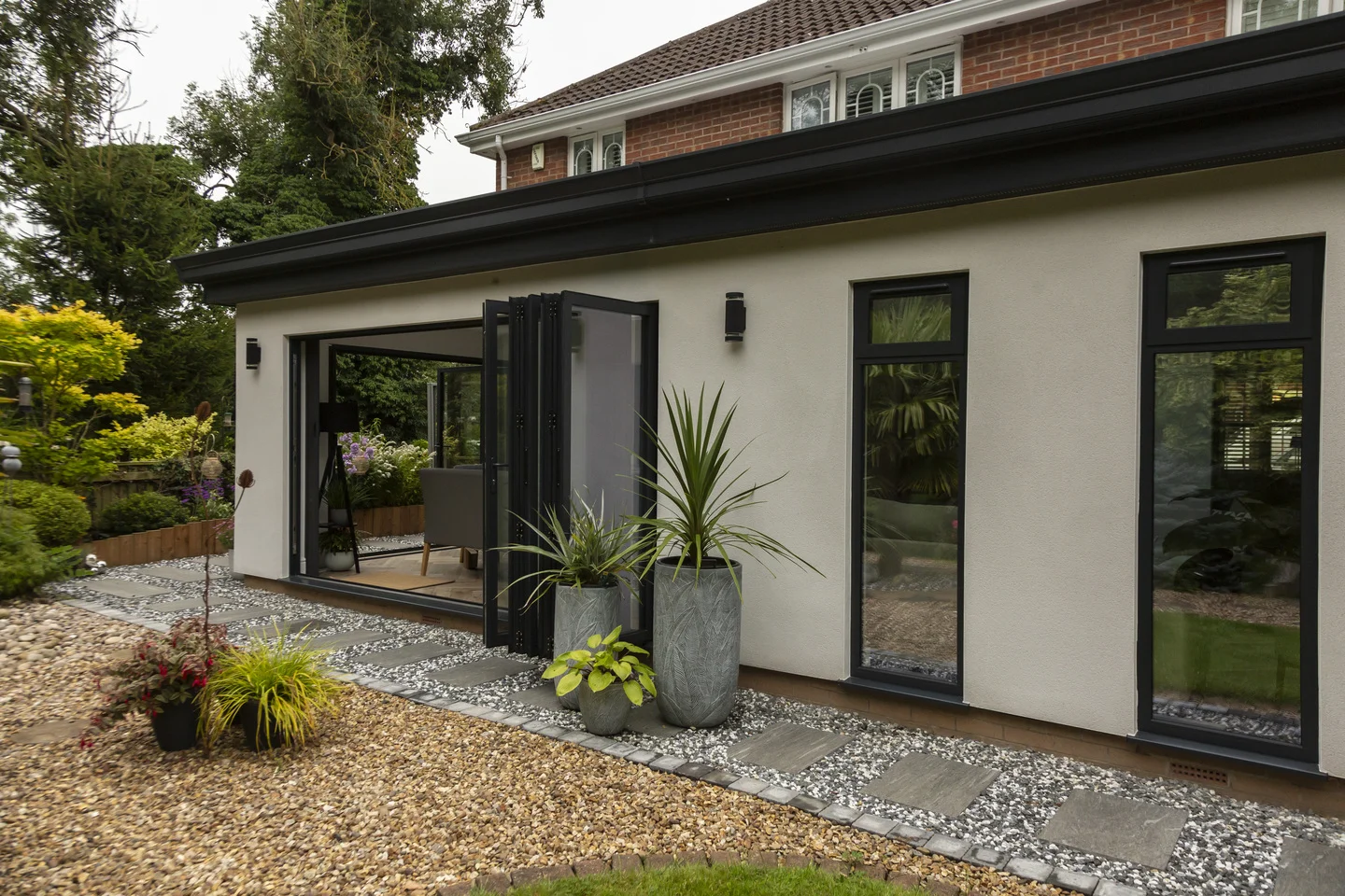 Exterior of extension on Yorkshire house with white rendering and bi-fold doors