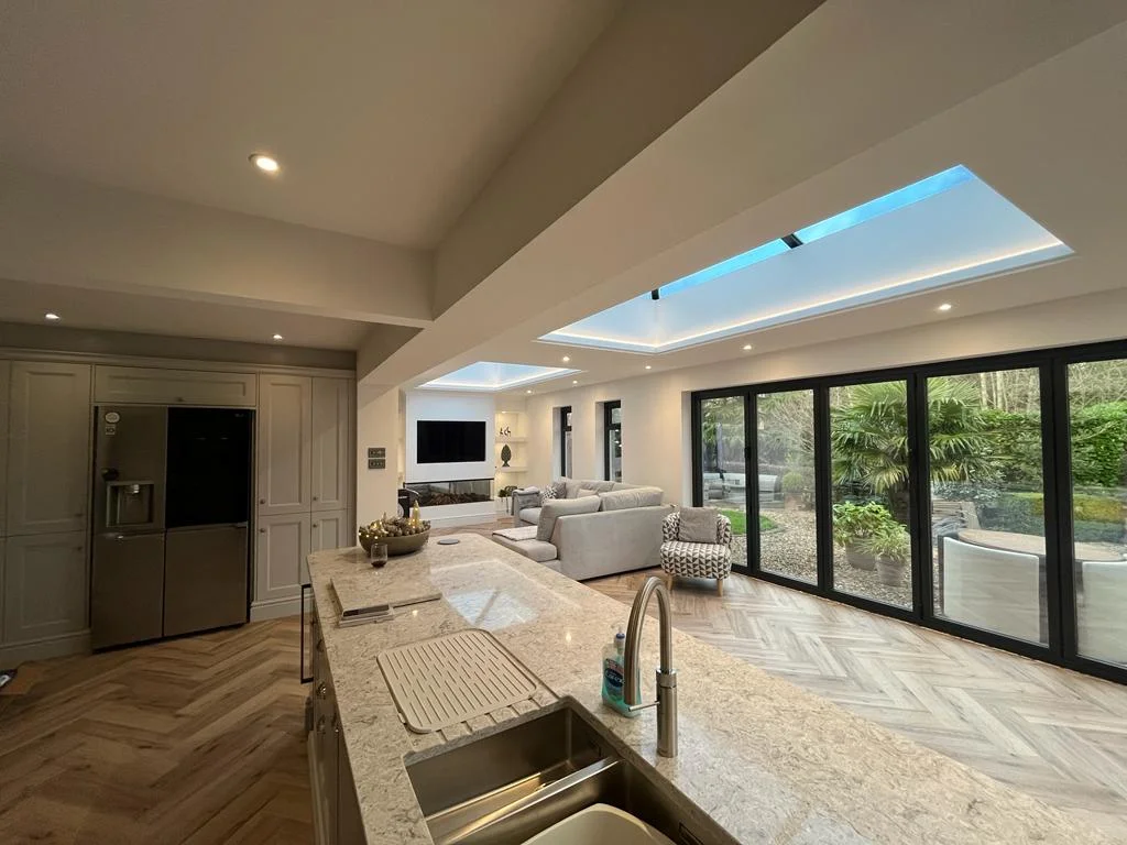 Wide angle view of modern open plan kitchen and large bi-fold doors