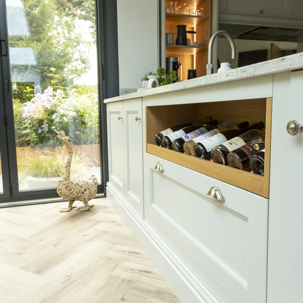 Close up of kitchen cupboards with wine rack and and modern decor