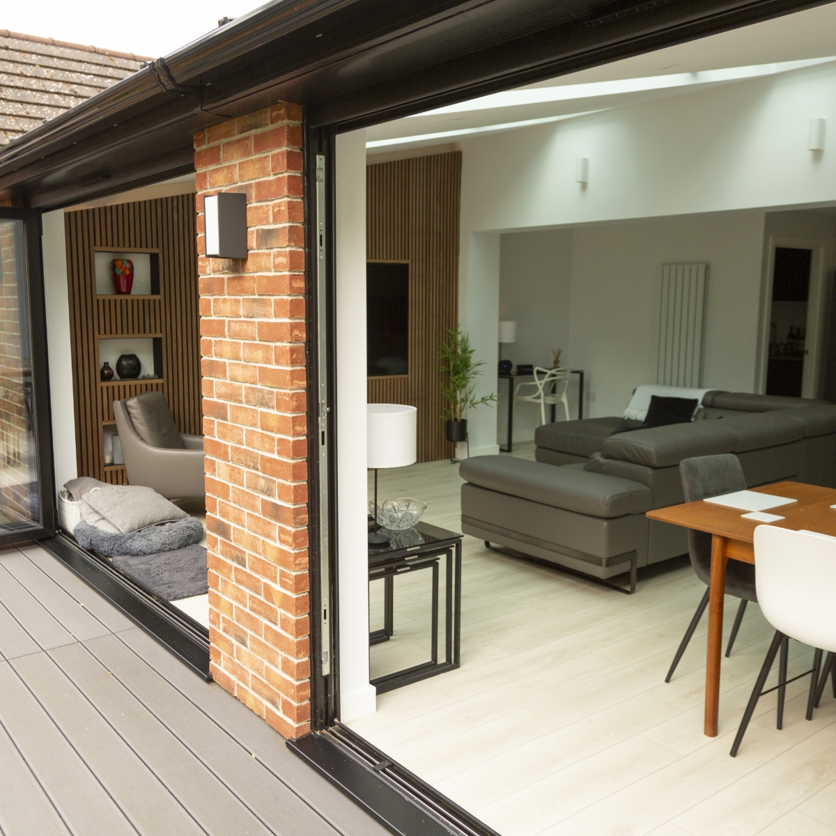 Brick orangery with bi-fold doors opening to open plan living room