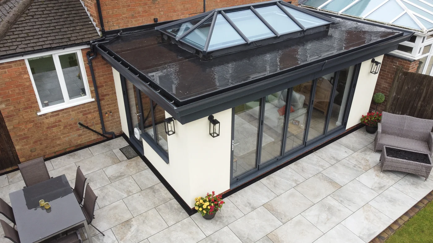Top view of new home extension with bi-fold doors and white rendering