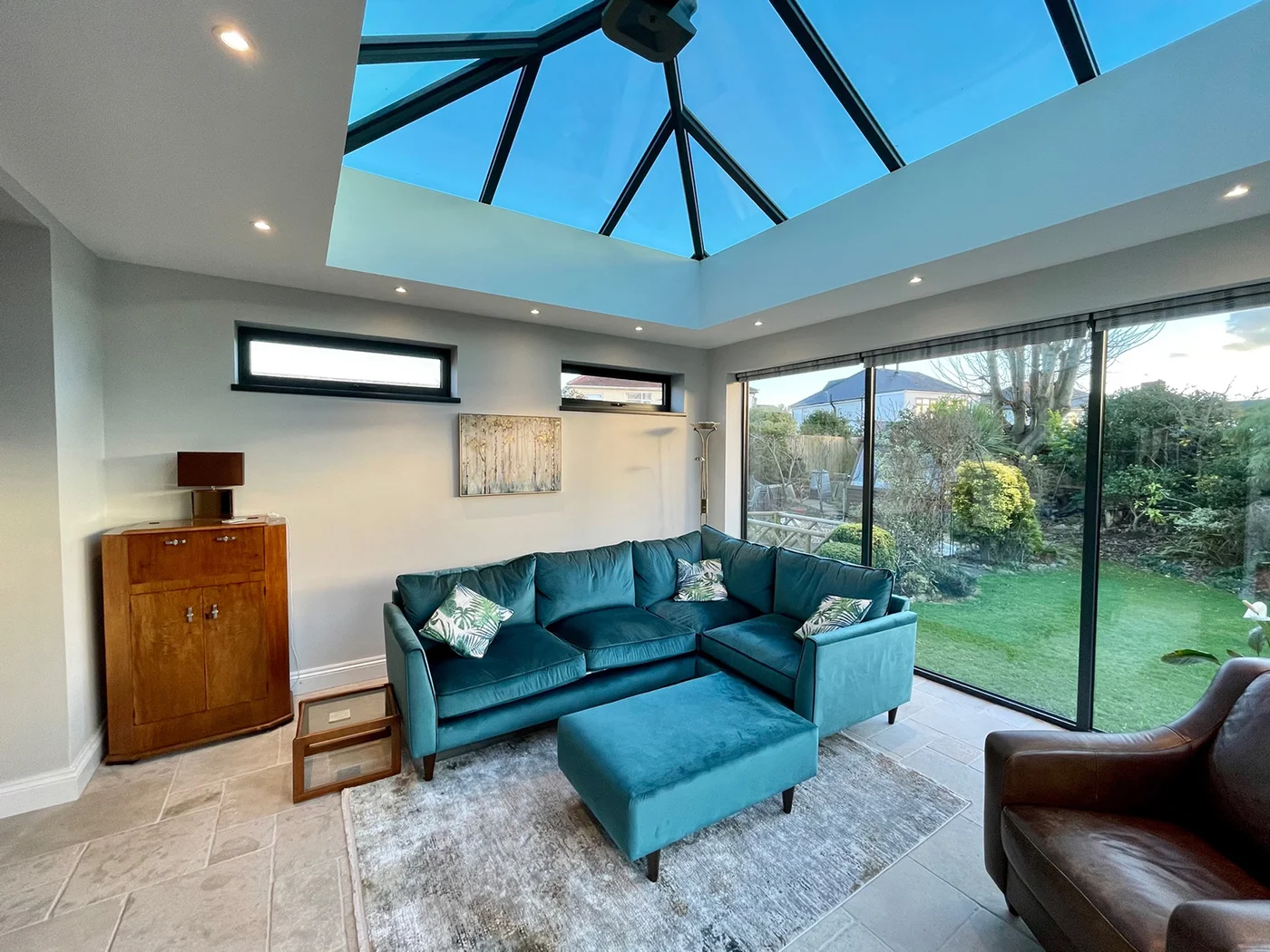 Large home extension in British home with lantern, bi-fold doors and cosy interior