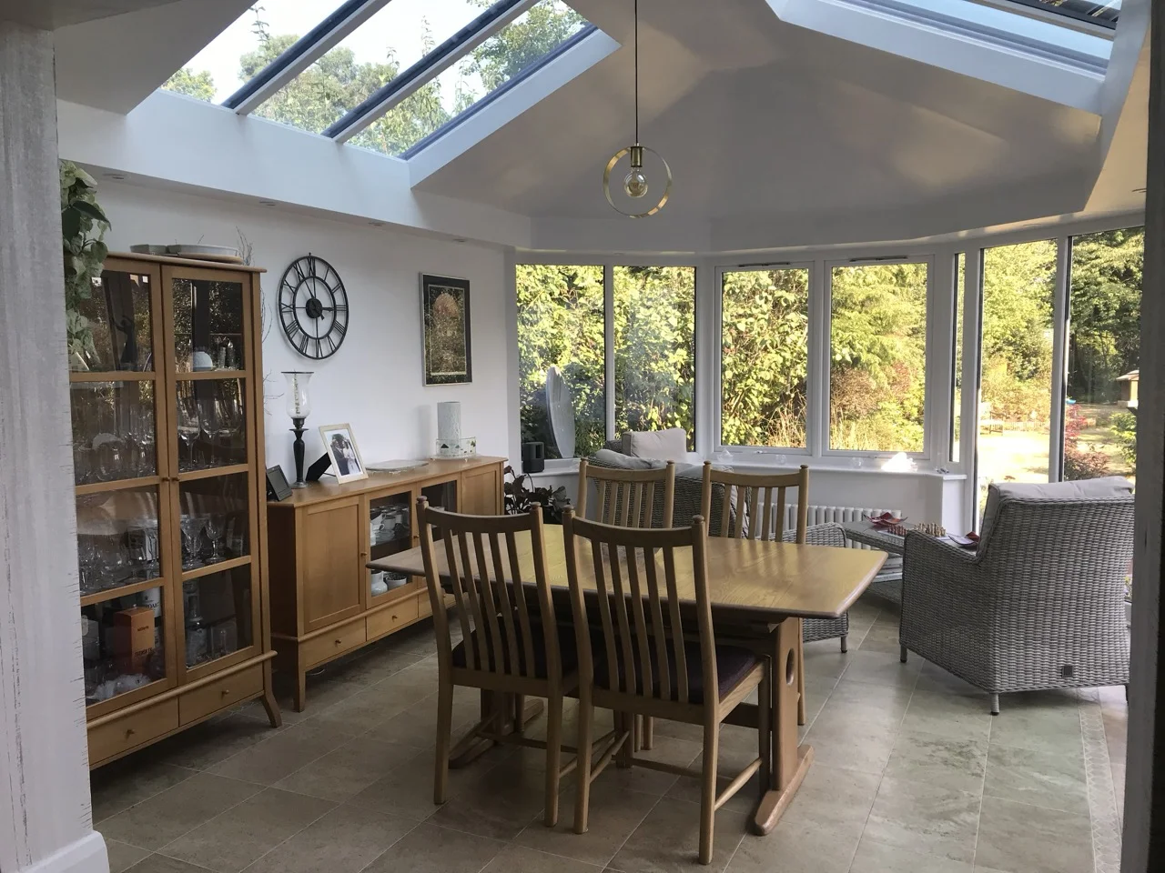 Inside family home conservatory with homely oak furniture