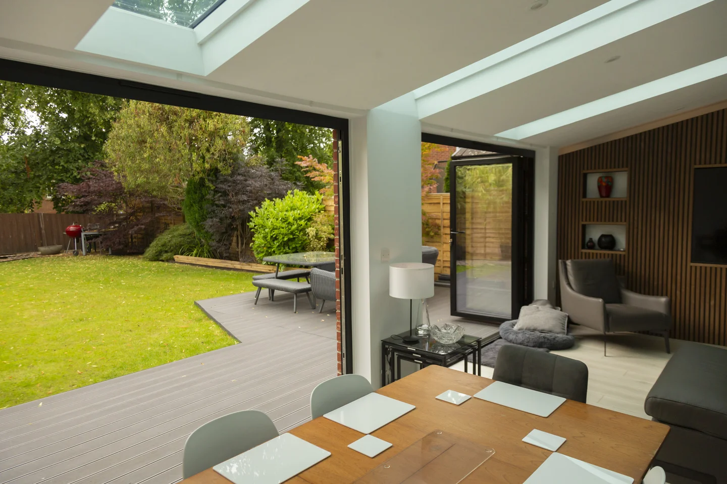 Large open plan family living space with modern wooden table and chairs