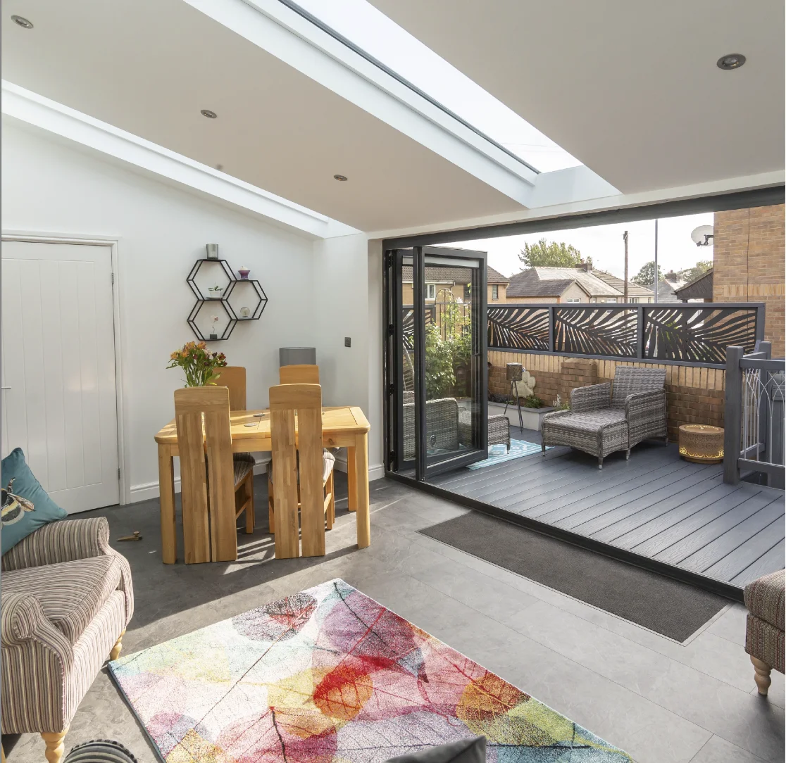 UK terraced house with lovely view of oak dining set and black framed bi-fold doors