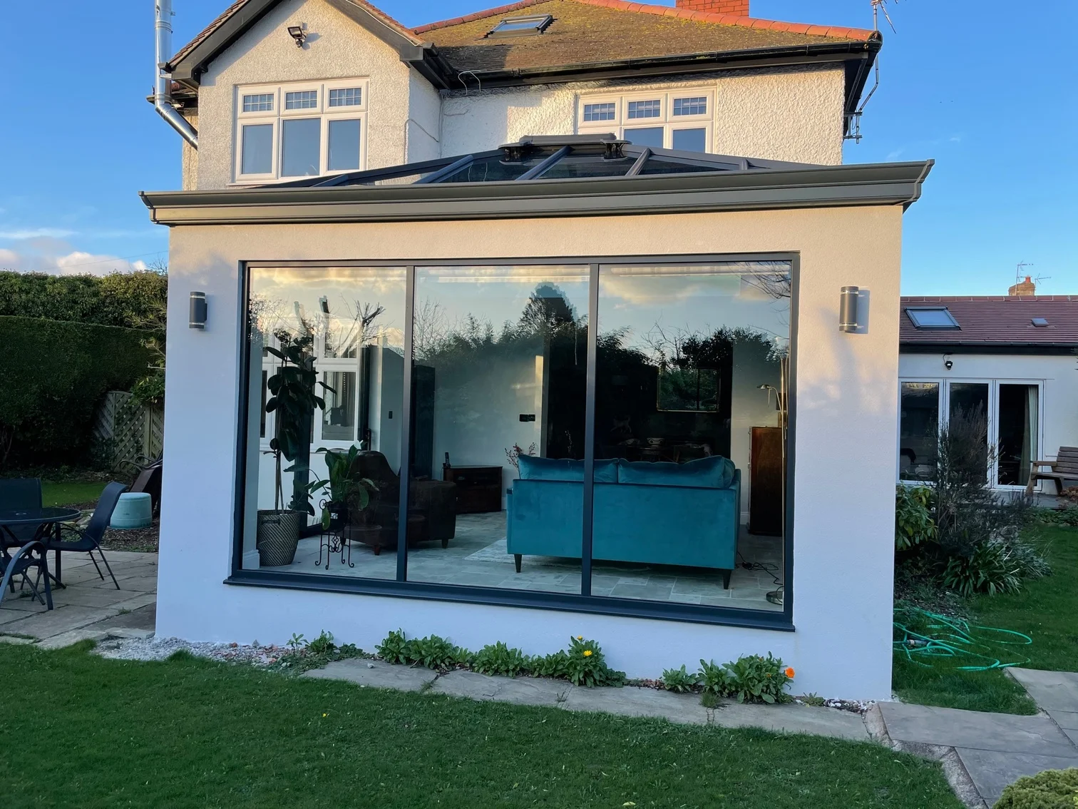 Orangery style extension with morning sun shining on house