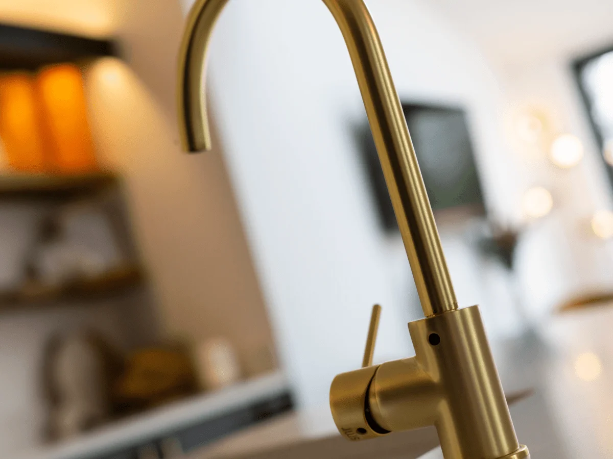 Modern brass tap and background of modern kitchen